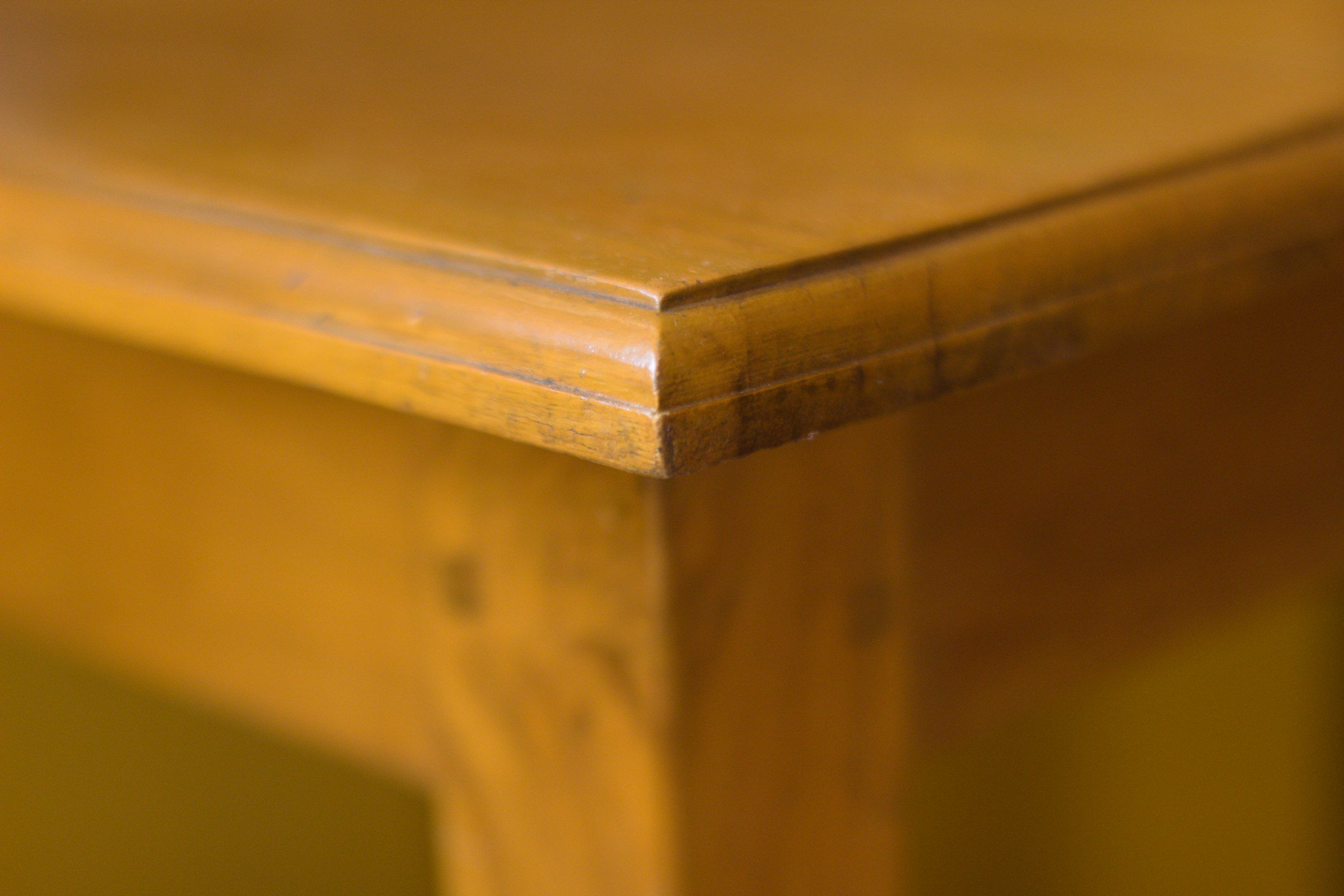 Close view of a profiled wood edge and the clean corner of a cabinet top