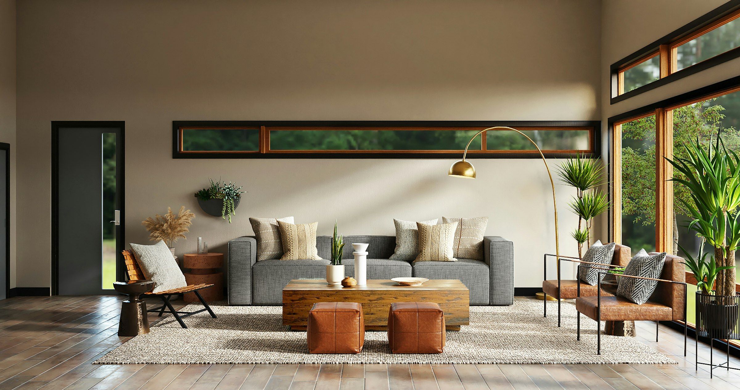 A warm, low-lit living room with a long sofa, leather ottomans and a band of clerestory windows