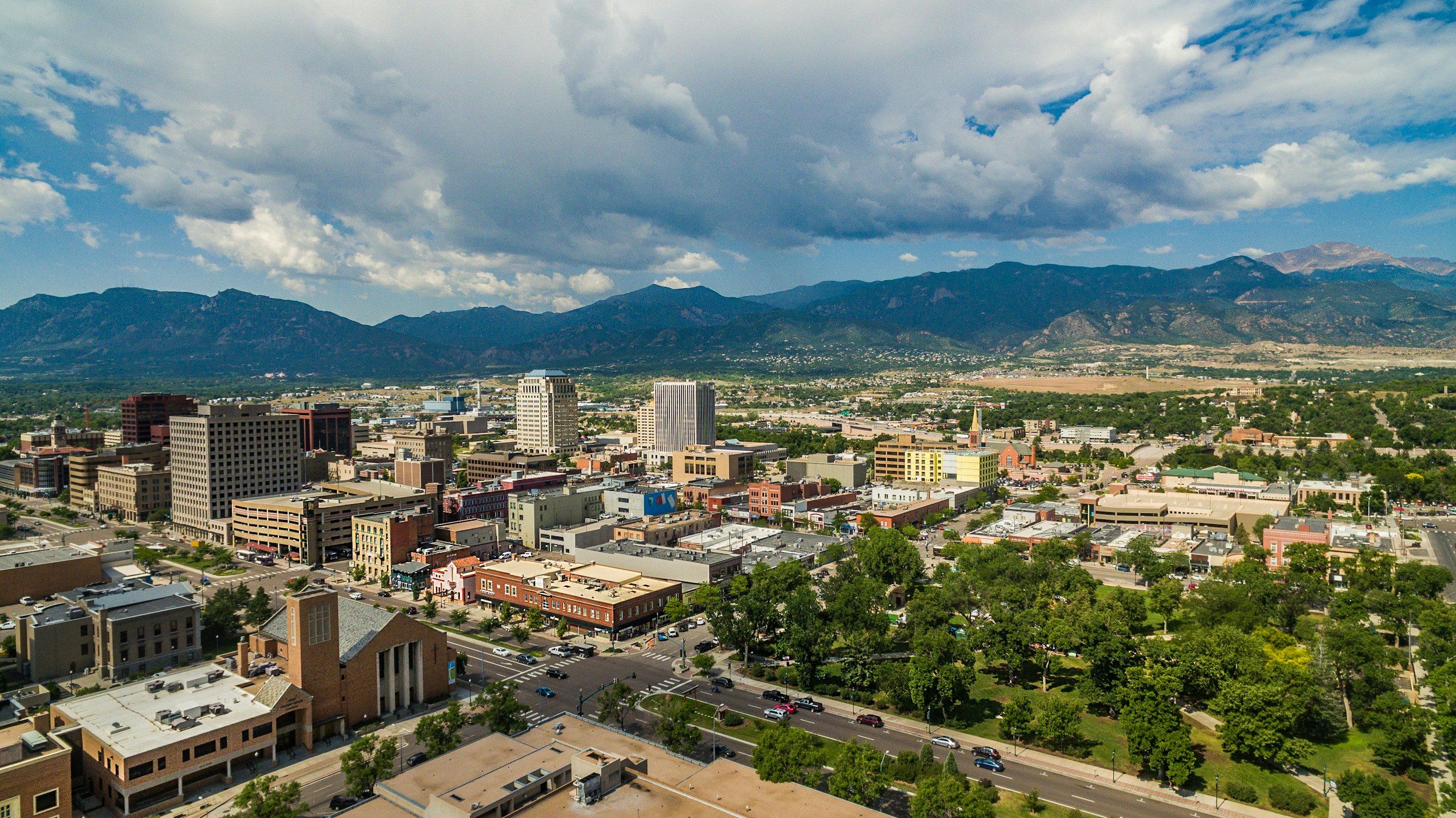 Downtown Colorado Springs from above, with Pikes Peak and the foothills behind it